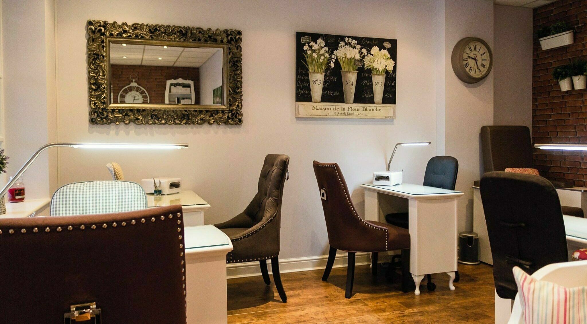 Chic nail studio in Belle La Vie, Binfield, England, GB showcasing plush chairs and ornate mirrors.