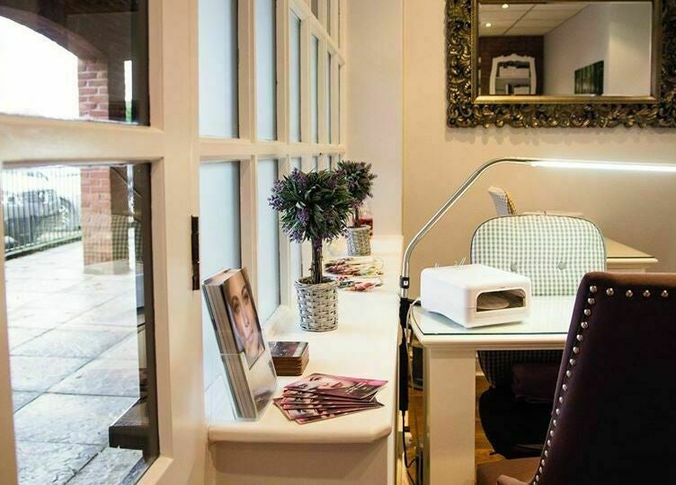 Inviting nail station at Belle La Vie, Binfield, England, GB, featuring cozy seating and elegant decor.