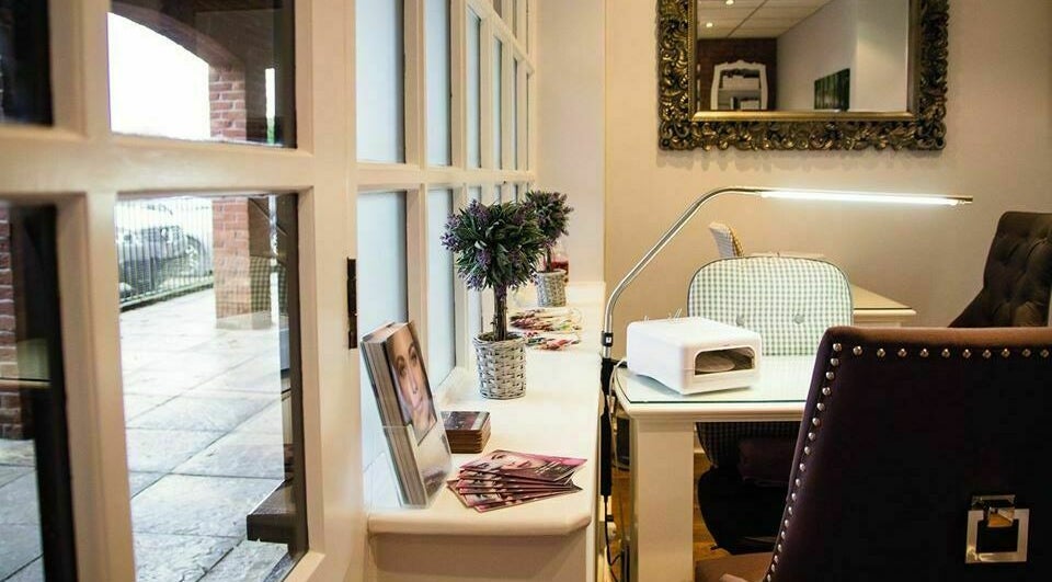 Inviting nail station at Belle La Vie, Binfield, England, GB, featuring cozy seating and elegant decor.