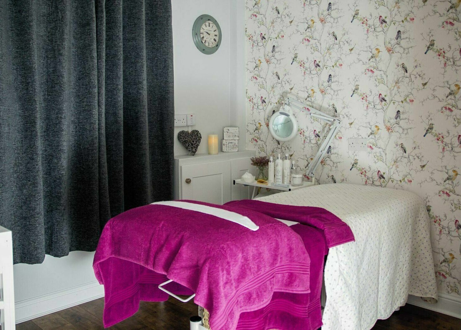 Serene treatment room at Belle La Vie in Binfield, England, GB with cozy massage table and elegant decor.