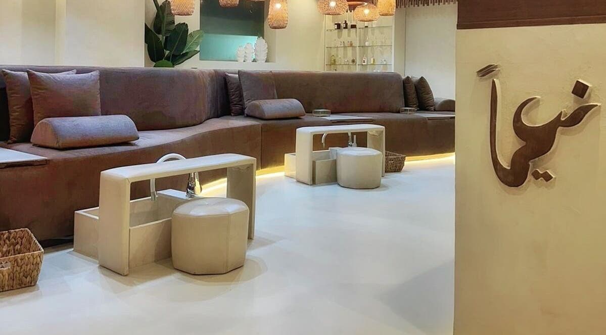 Elegant seating area at Naeeman Salon صالون نعيماً in Jabriya, Hawalli Governorate, KW with plush couches and modern decor.