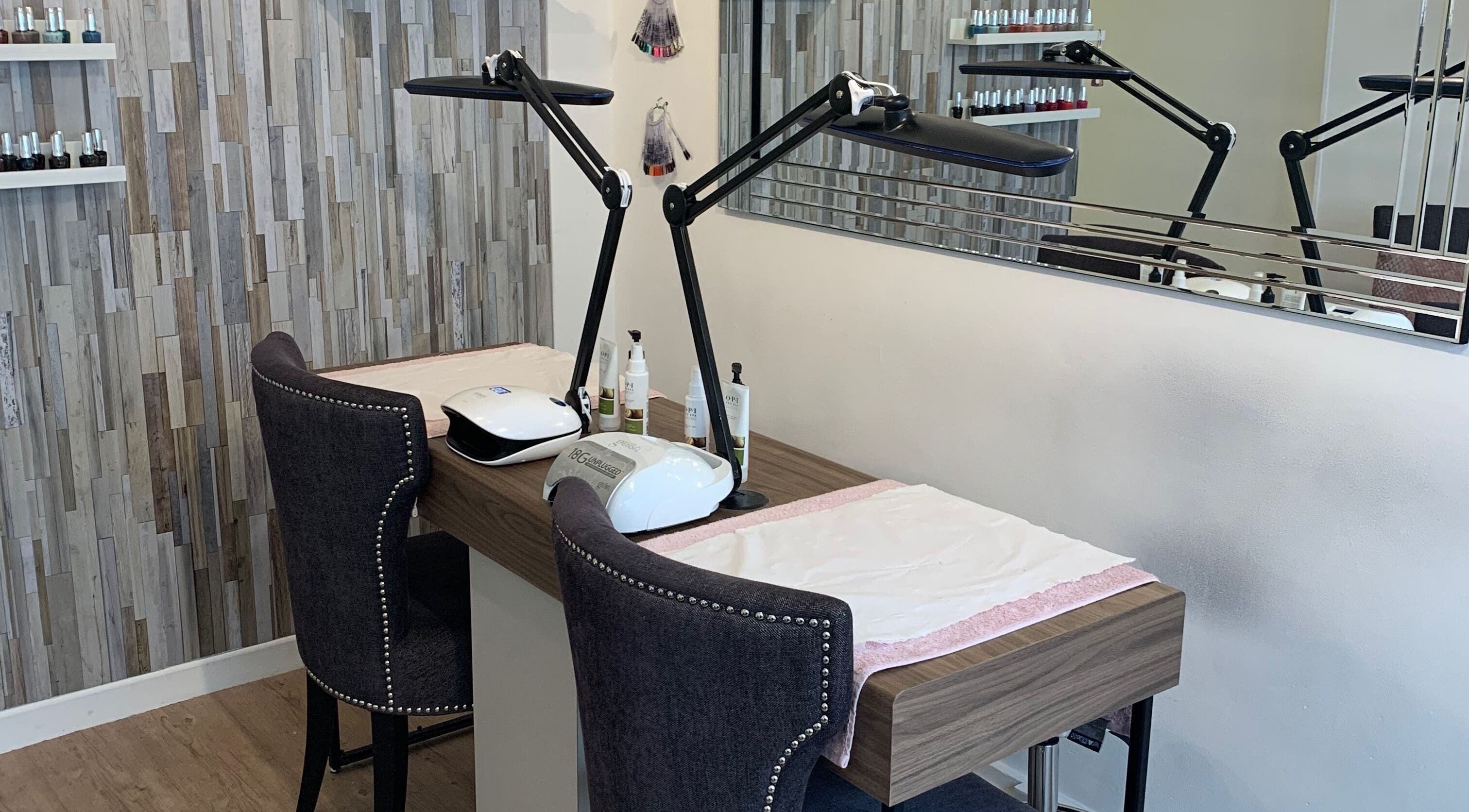 Nail station at Divine Health and Beauty, Manningtree, England, GB, showcasing modern decor and equipment.
