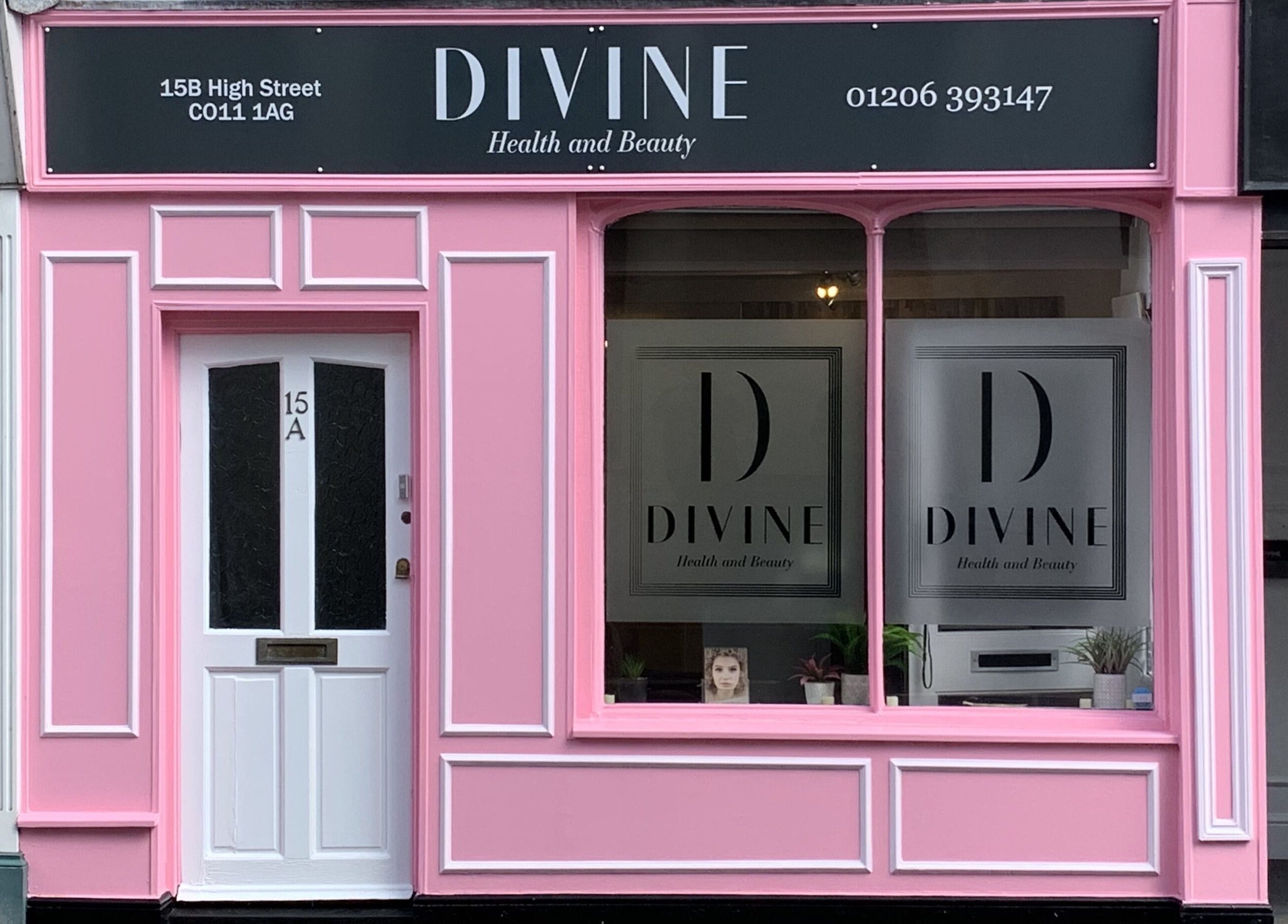Bright pink facade of Divine Health and Beauty in Manningtree, England, GB.