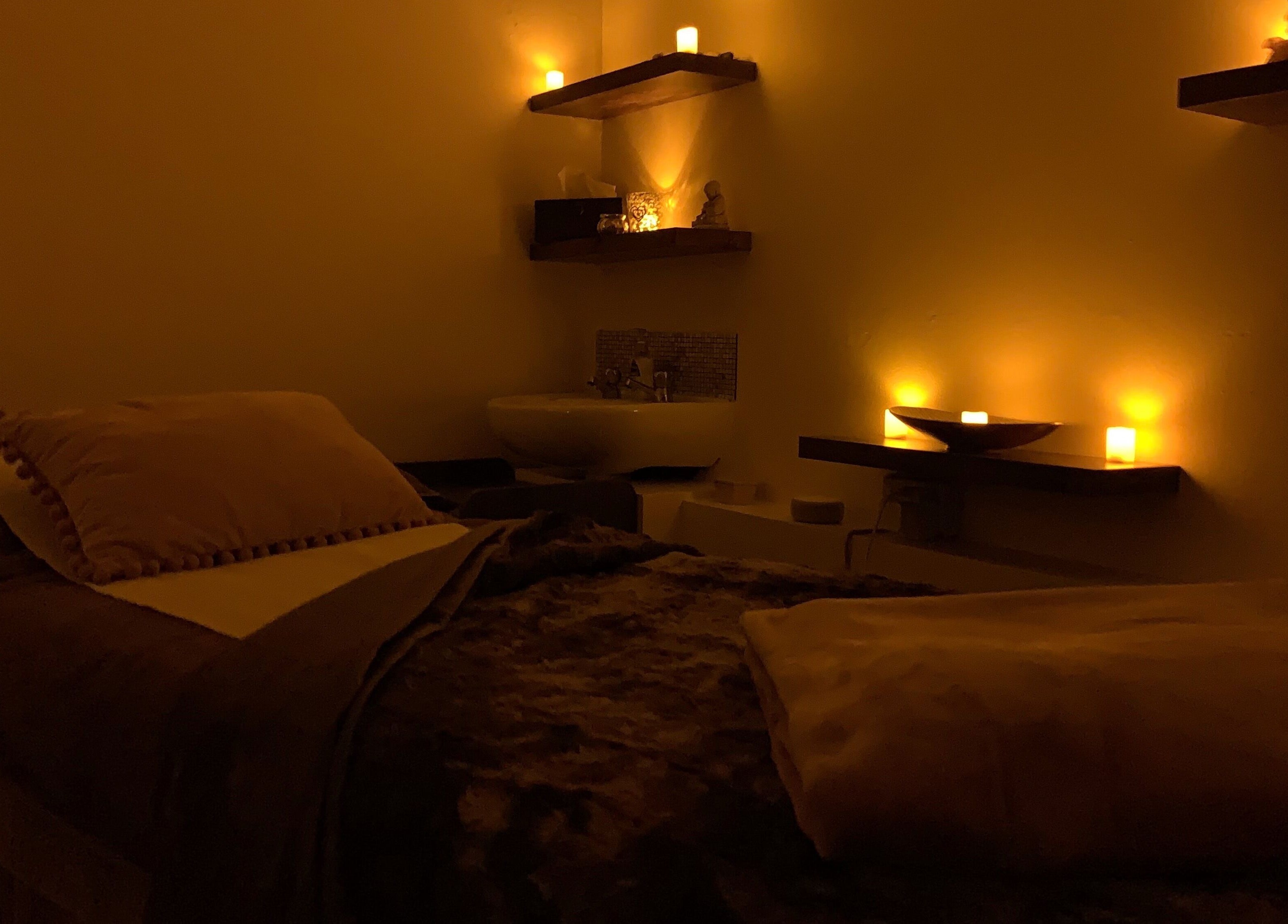 Relaxing massage room with candles at Divine Health and Beauty, Manningtree, England, GB.