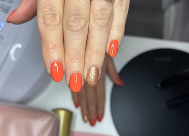 Orange and gold glitter nails styled at The Beauty House, THURSO, Scotland, GB. Perfect for a chic look.