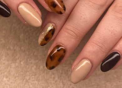 Stylish fall-themed nail art at The Beauty House, THURSO, Scotland, GB featuring warm tones and leopard print.