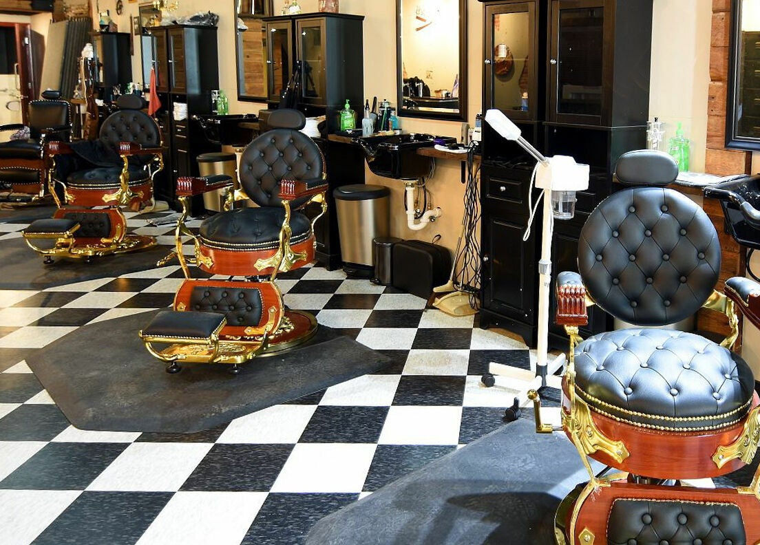 Elegant barber chairs at Two-Bit Barber Company in Sedalia, Missouri, US showcasing classic grooming style.