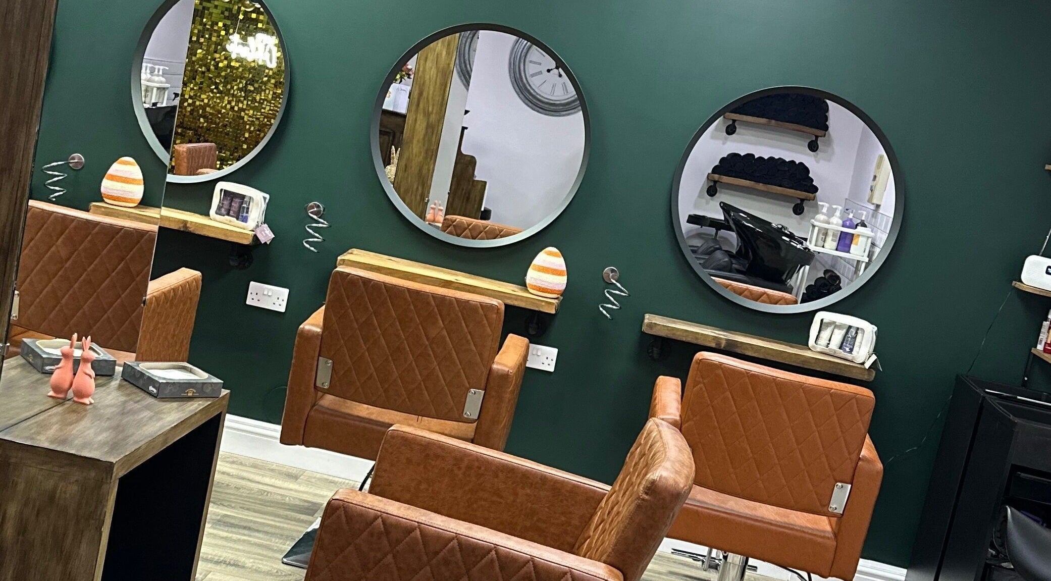 Stylish salon interior with round mirrors at House of Hair, Wombwell, England, GB.