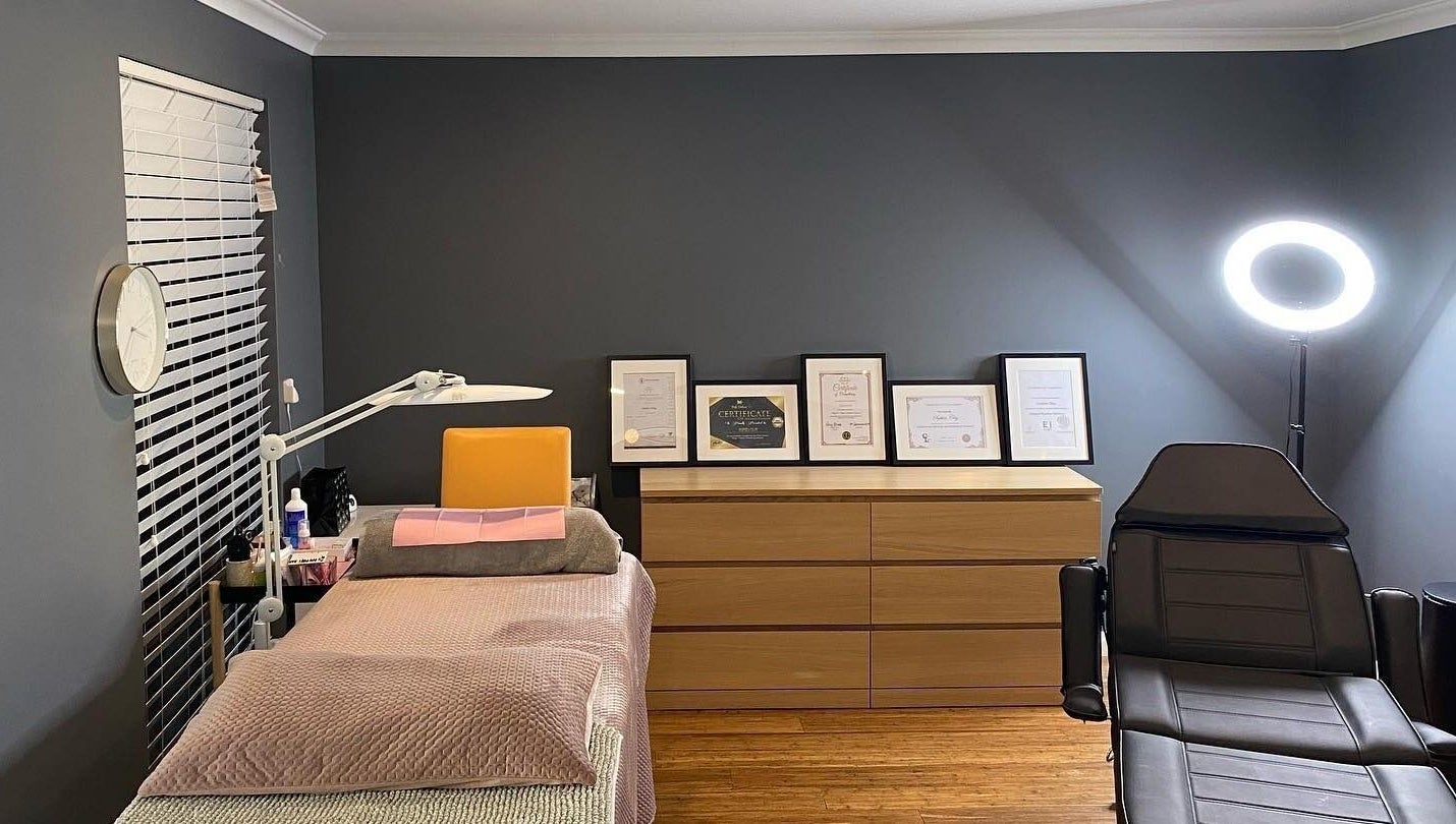 Cozy interior of Blinq Lashes in Stirling, Western Australia, AU with bed, certificates, and ring light.
