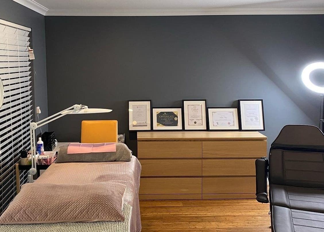 Cozy interior of Blinq Lashes in Stirling, Western Australia, AU with bed, certificates, and ring light.