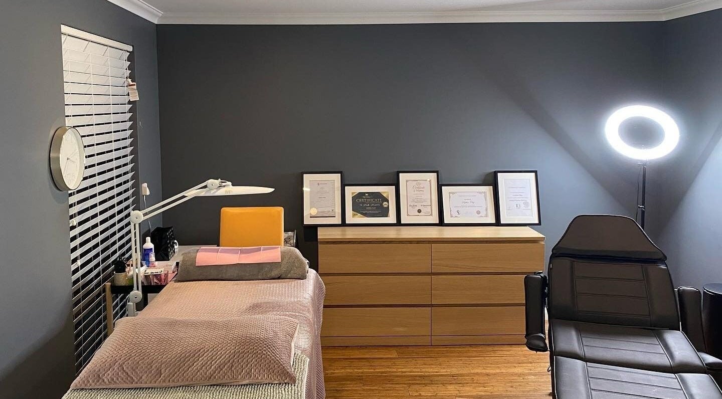Cozy interior of Blinq Lashes in Stirling, Western Australia, AU with bed, certificates, and ring light.