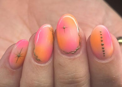 Vibrant pink and orange nail art with intricate designs at Classic Beauty Boutique, Bournemouth, England, GB.