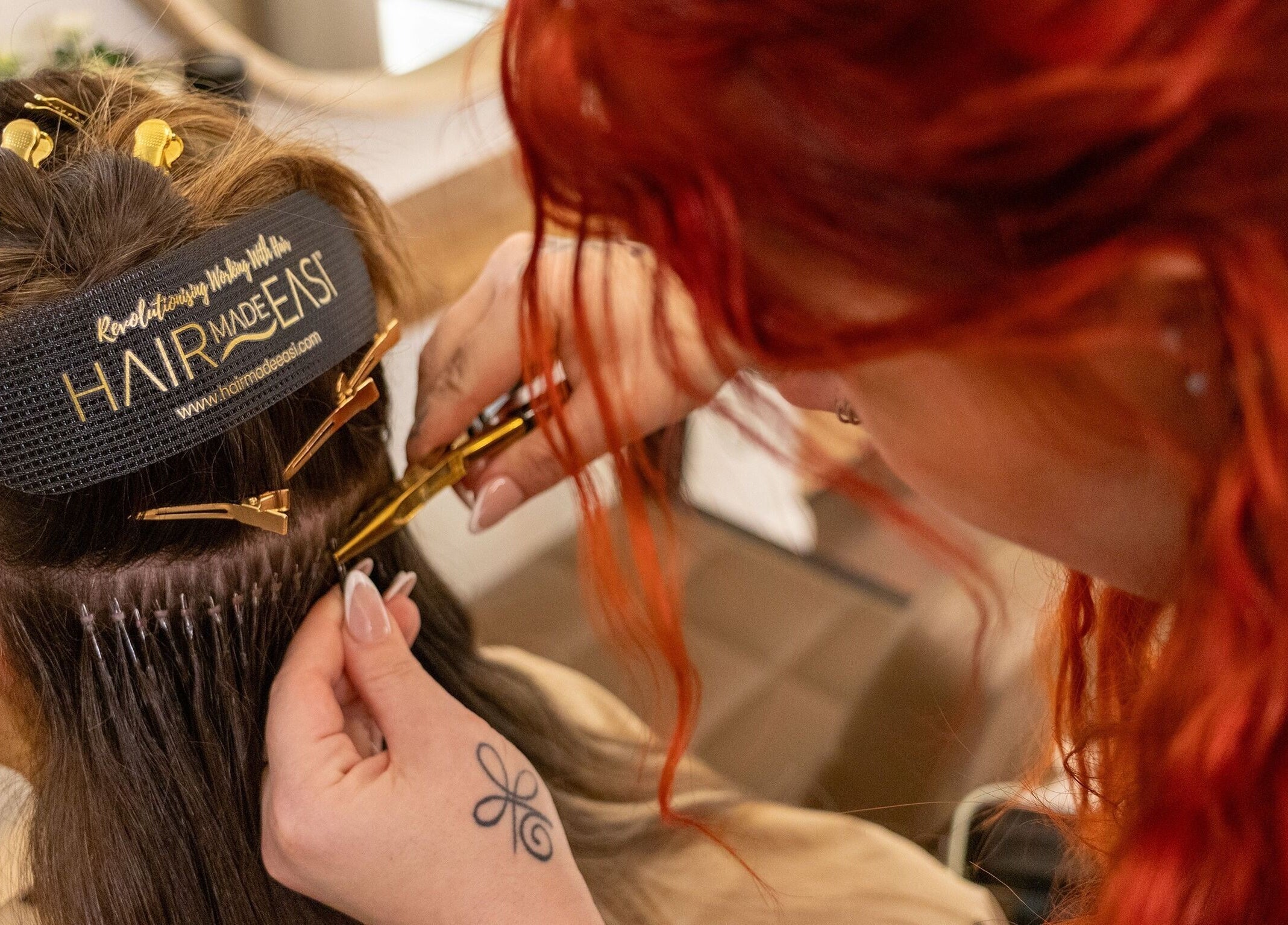 Stylist at Classic Beauty Boutique applying hair extensions in Bournemouth, England, GB.