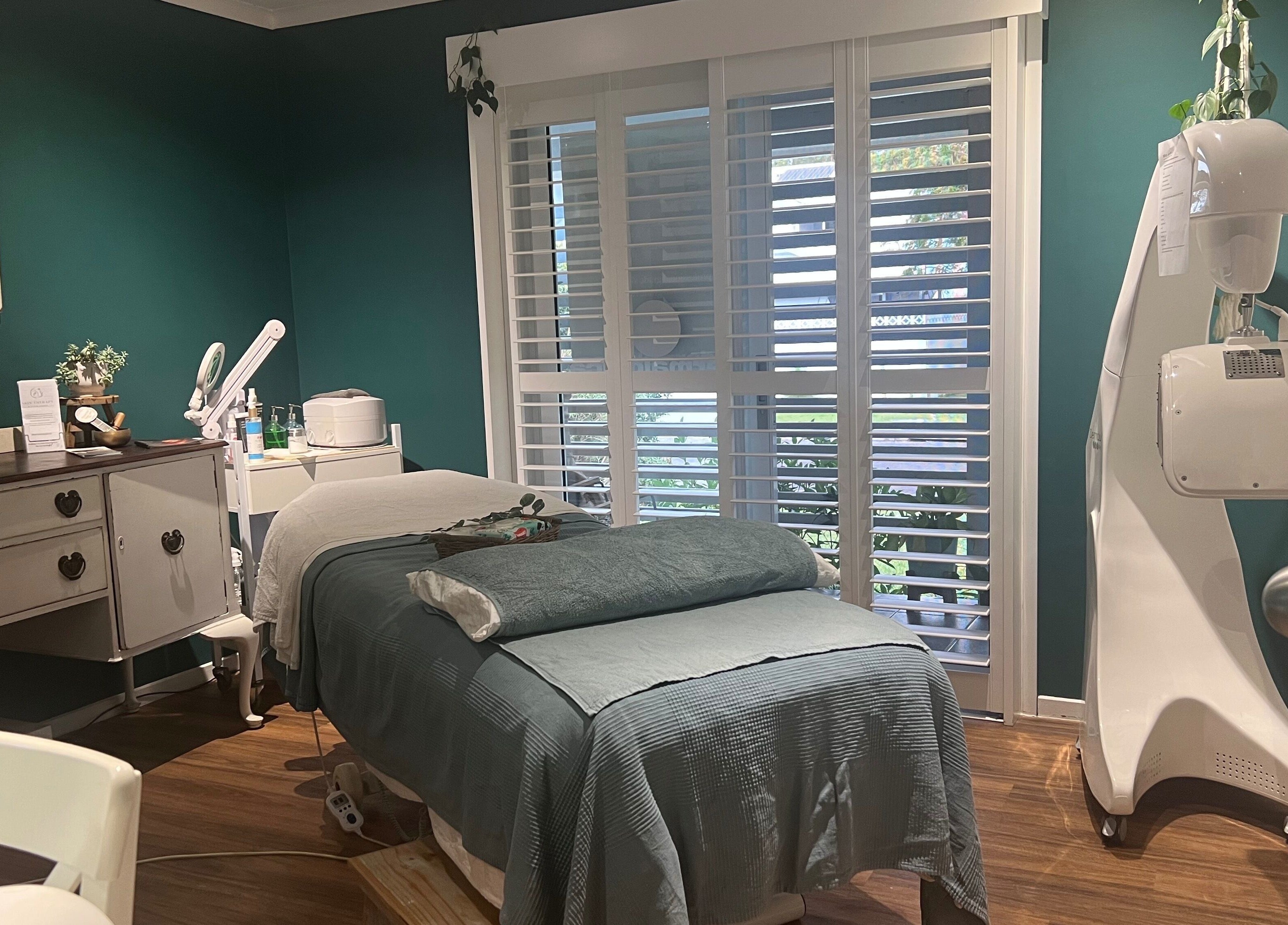 Cozy spa room at Skin Therapy at Ocean Shores, New South Wales, AU, featuring a treatment bed and beauty equipment.