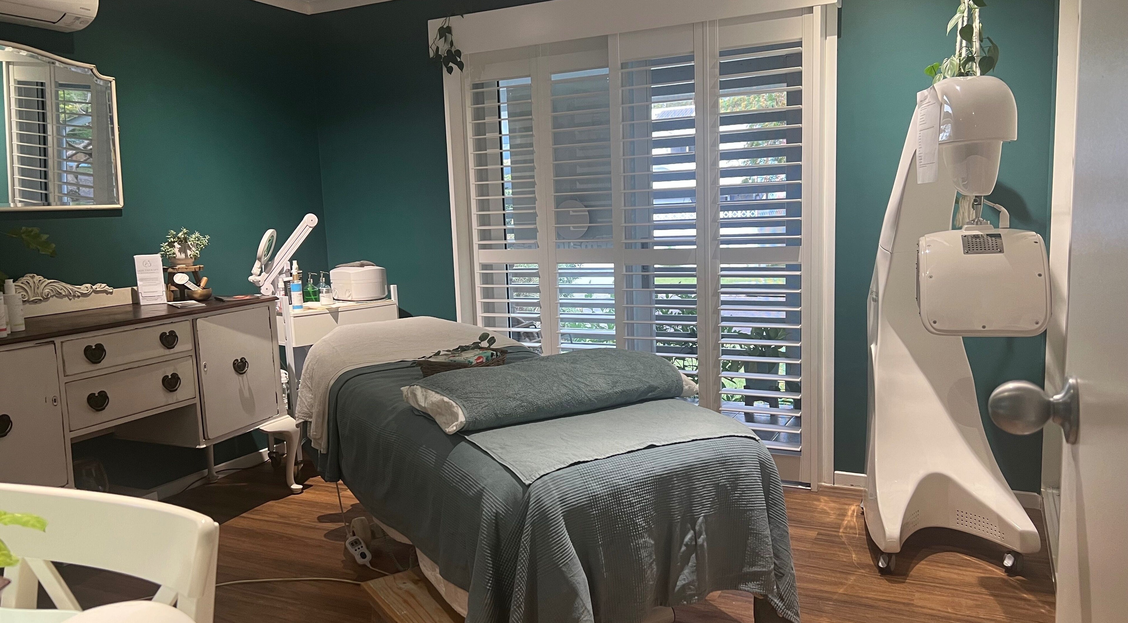 Cozy spa room at Skin Therapy at Ocean Shores, New South Wales, AU, featuring a treatment bed and beauty equipment.