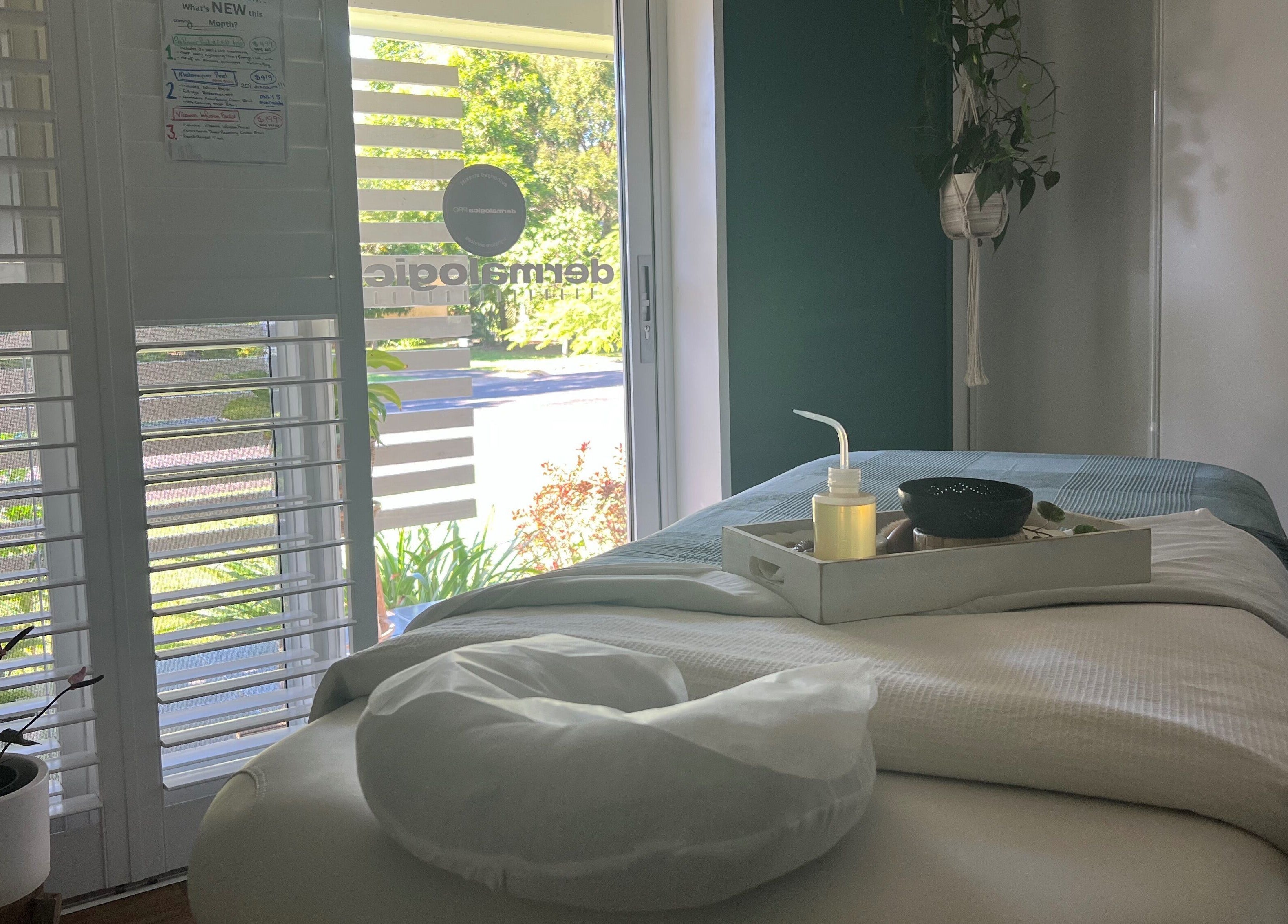Calm spa room at Skin Therapy at Ocean Shores, NSW, AU, featuring massage table and natural light.