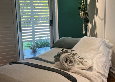 Relaxing spa room at Skin Therapy at Ocean Shores, ocean shores, New South Wales, AU. Cozy bed and serene decor.