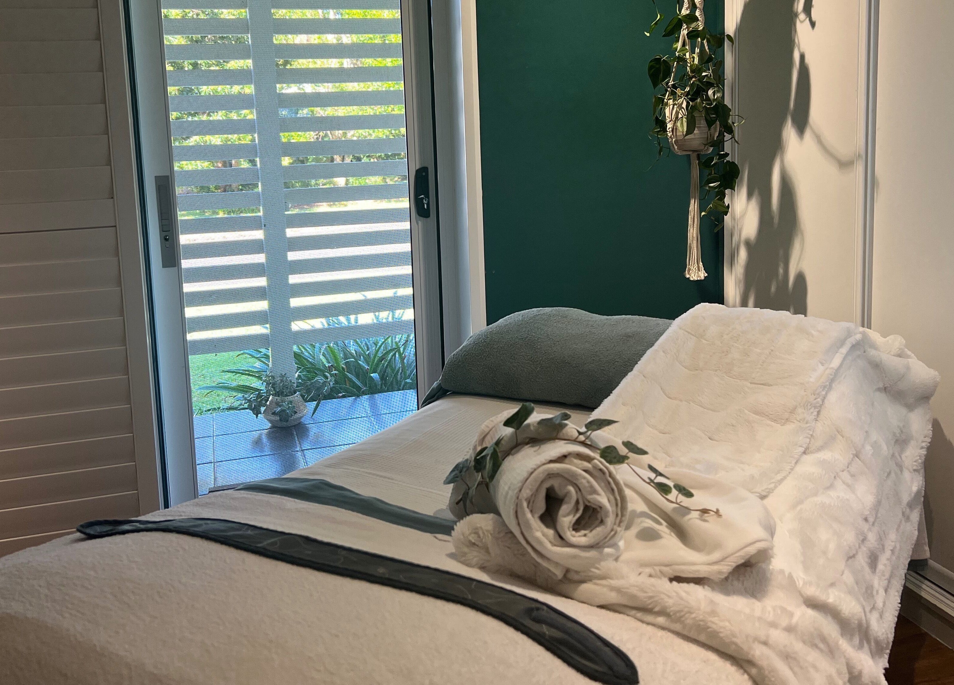 Relaxing spa room at Skin Therapy at Ocean Shores, ocean shores, New South Wales, AU. Cozy bed and serene decor.