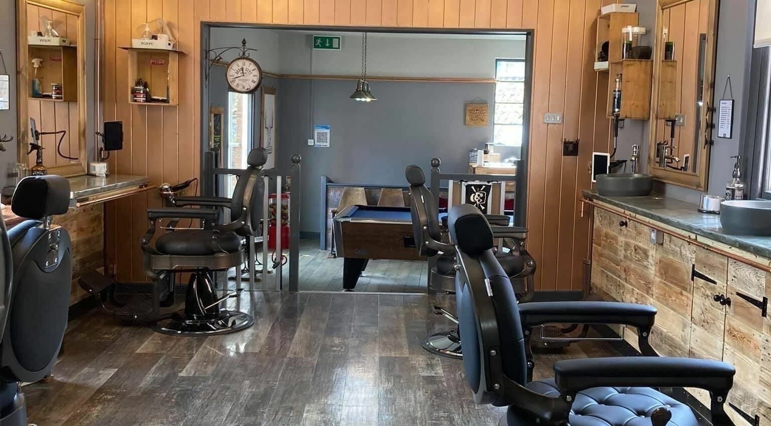 Stylish barbershop chairs at The Handsome Stag, Bridgwater, England, GB, showcase a trendy and welcoming space.