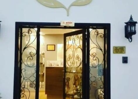 Welcoming entrance to Spa Lounge in Muscat, Muscat Governorate, OM, featuring ornate wrought-iron doors.