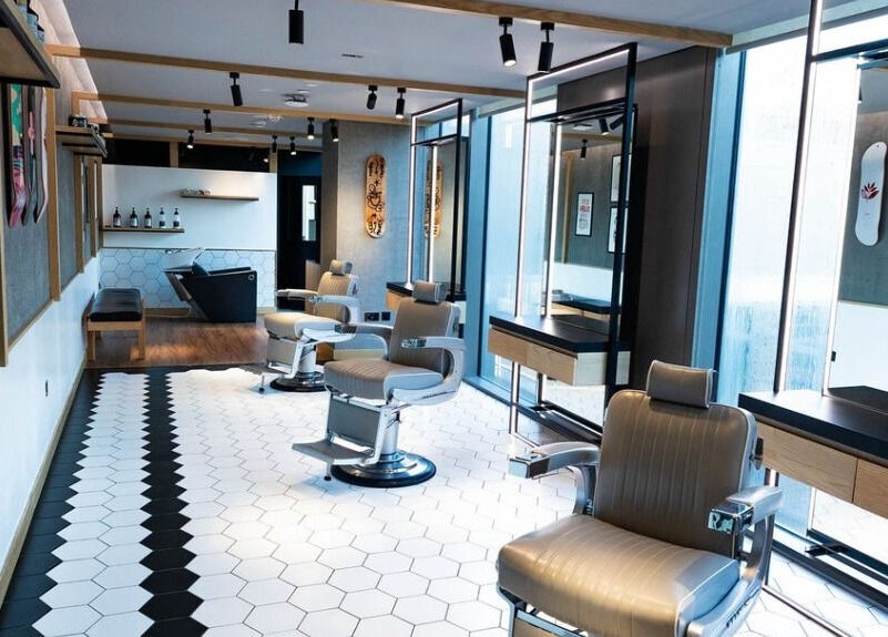 Modern interior of Akin Barber and Shop at 25 Hours Hotel, Dubai, Dubai, AE, showcasing stylish barber chairs.