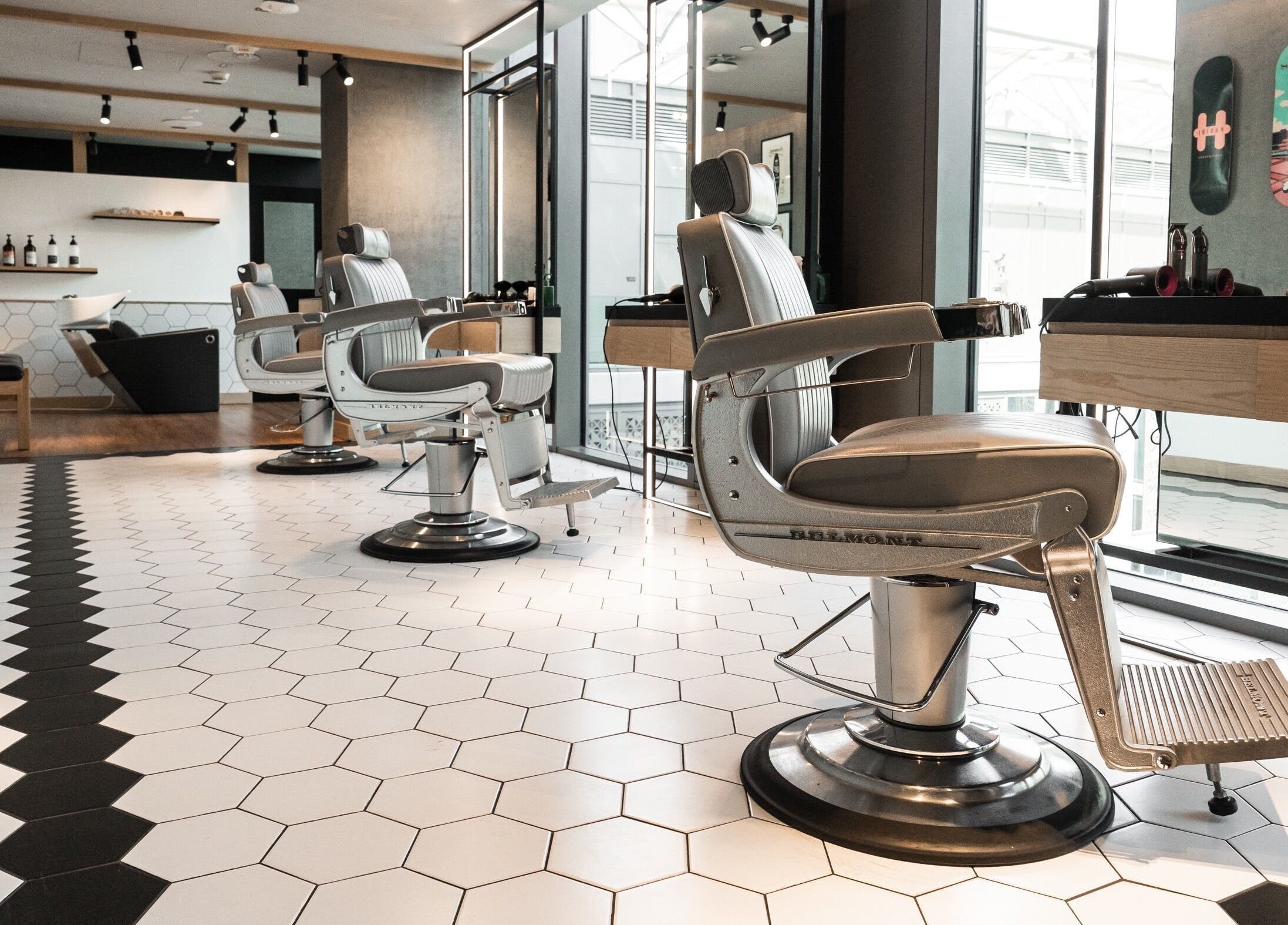 Stylish interior of Akin Barber and Shop at 25 Hours Hotel in Dubai, Dubai, AE with modern barber chairs.
