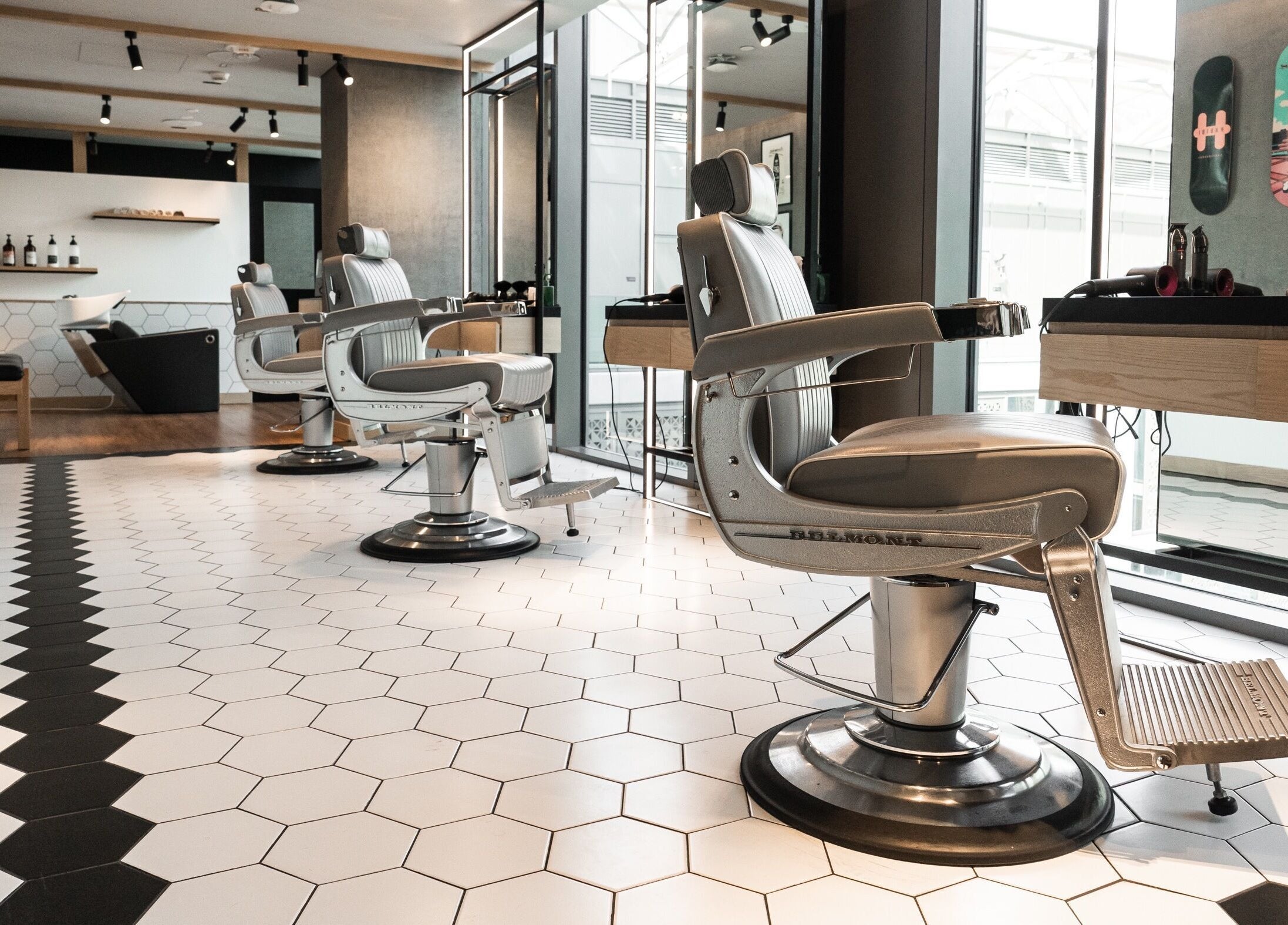 Stylish interior of Akin Barber and Shop at 25 Hours Hotel in Dubai, Dubai, AE with modern barber chairs.