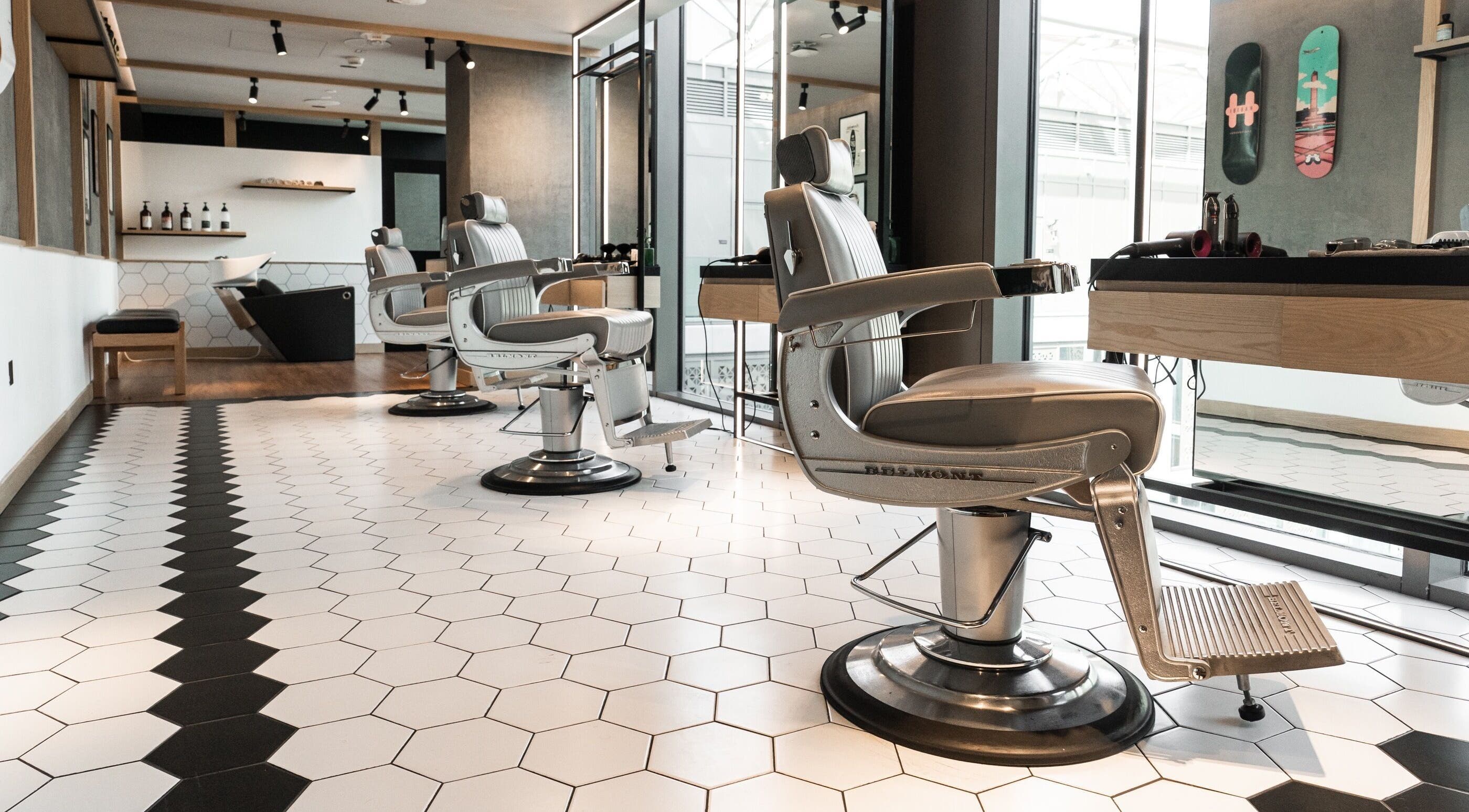 Stylish interior of Akin Barber and Shop at 25 Hours Hotel in Dubai, Dubai, AE with modern barber chairs.