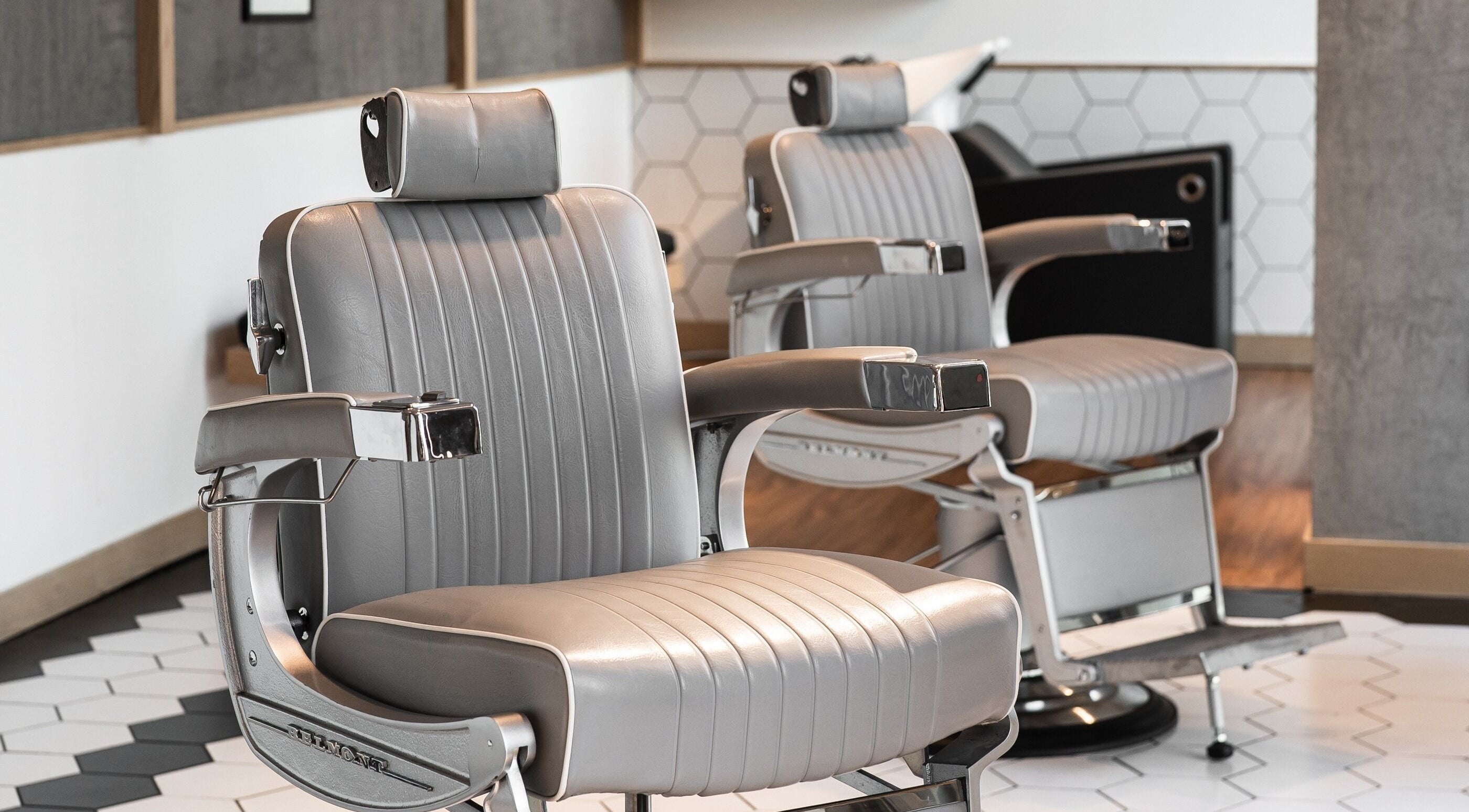 Modern barber chairs at Akin Barber and Shop, 25 Hours Hotel, Dubai, Dubai, AE, offering sleek comfort.