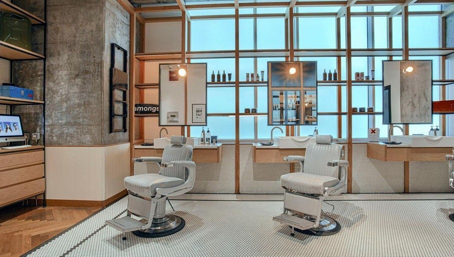Modern barber chairs at Akin Barber & Shop Burj Al Salam, Dubai, AE offer a stylish grooming experience.