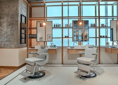 Modern barber chairs at Akin Barber & Shop Burj Al Salam, Dubai, AE offer a stylish grooming experience.