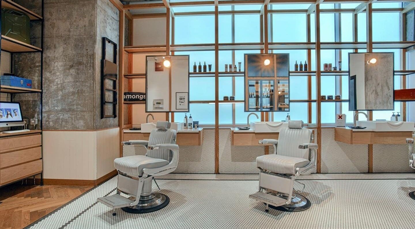 Modern barber chairs at Akin Barber & Shop Burj Al Salam, Dubai, AE offer a stylish grooming experience.