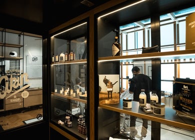 Inside Akin Barber & Shop Burj Al Salam, Dubai, AE featuring sleek interior and grooming products display.