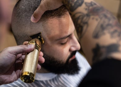 Close-up of barber giving a precise haircut at Akin Barber & Shop Burj Al Salam, Dubai, AE.