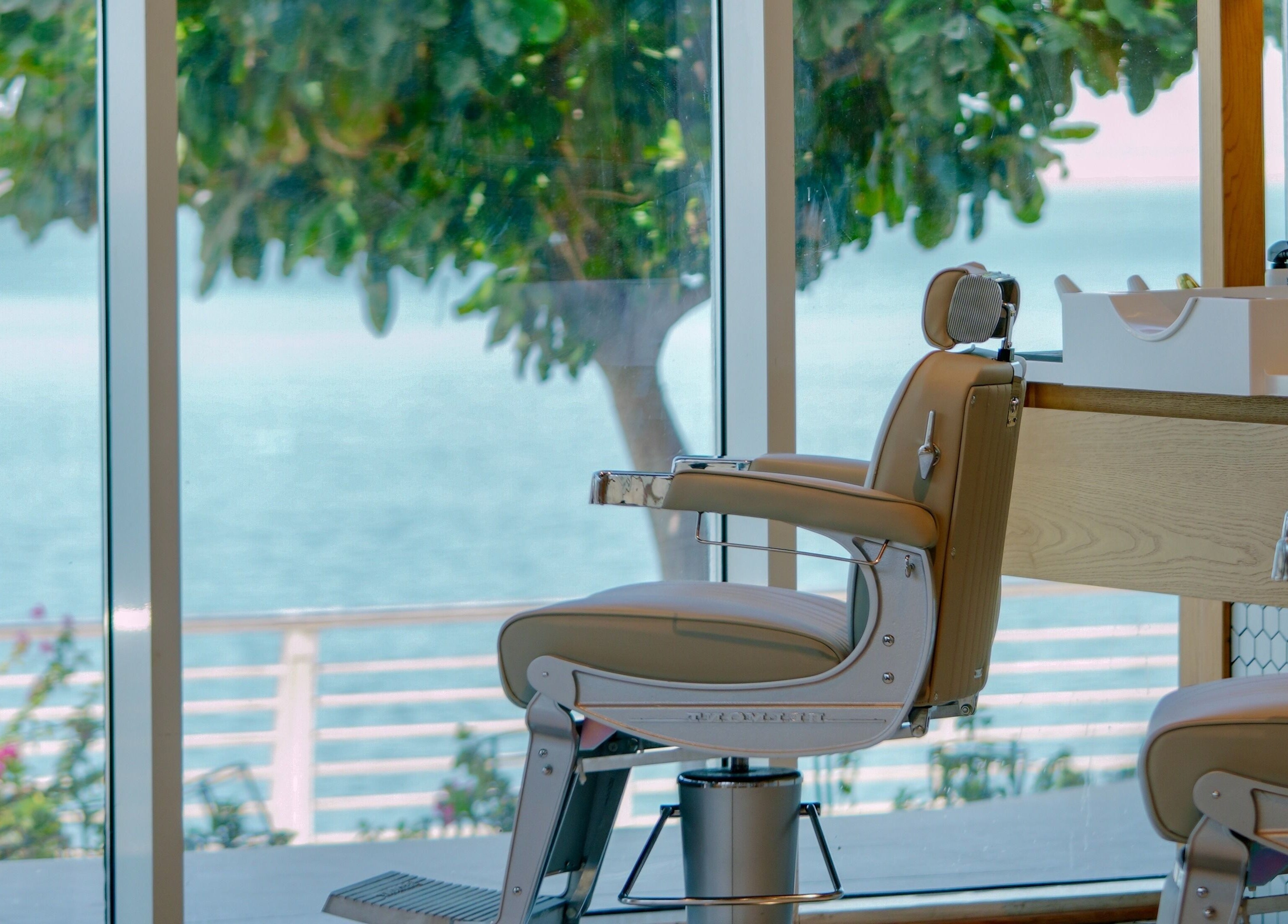 Barber chair overlooking sea at Akin Barber & Shop AbuDhabi By The Creek, Abu Dhabi, AE. Relaxing view.