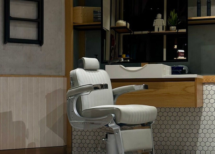 Modern barber chair at Akin Barber & Shop AbuDhabi By The Creek in Abu Dhabi, AE, combining comfort and style.
