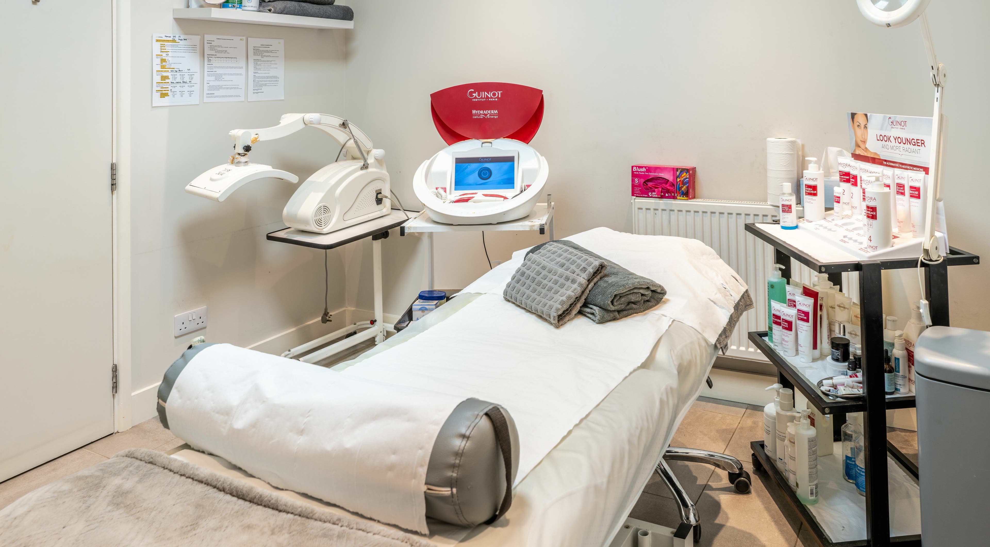 Modern treatment room at Hawkins Clinic in London, England, GB featuring advanced skincare equipment and products.