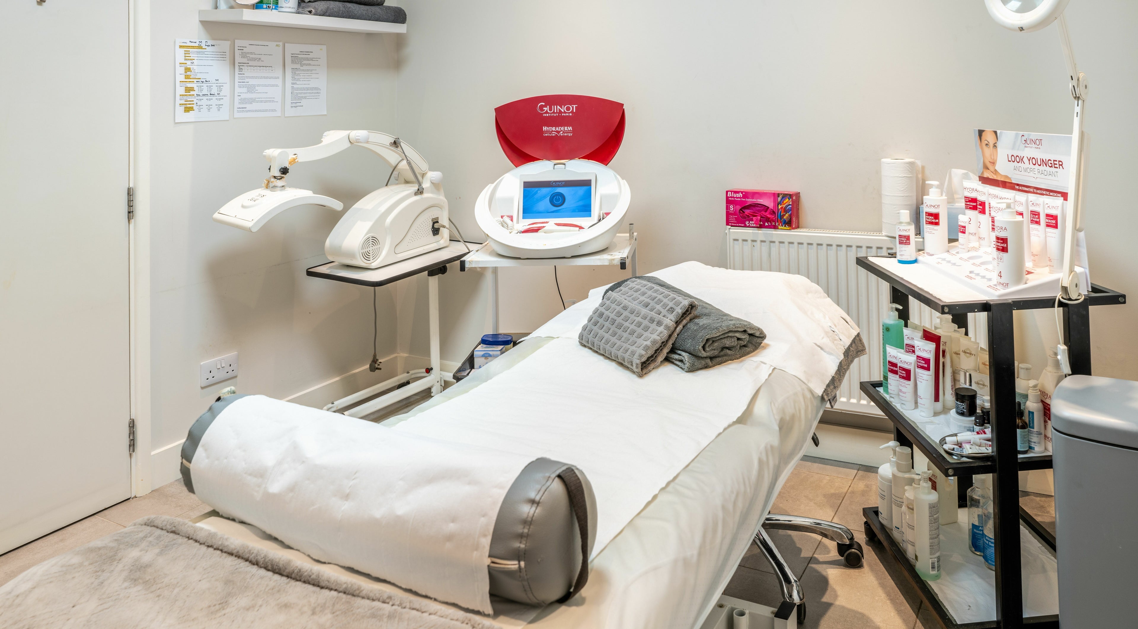 Modern treatment room at Hawkins Clinic in London, England, GB featuring advanced skincare equipment and products.