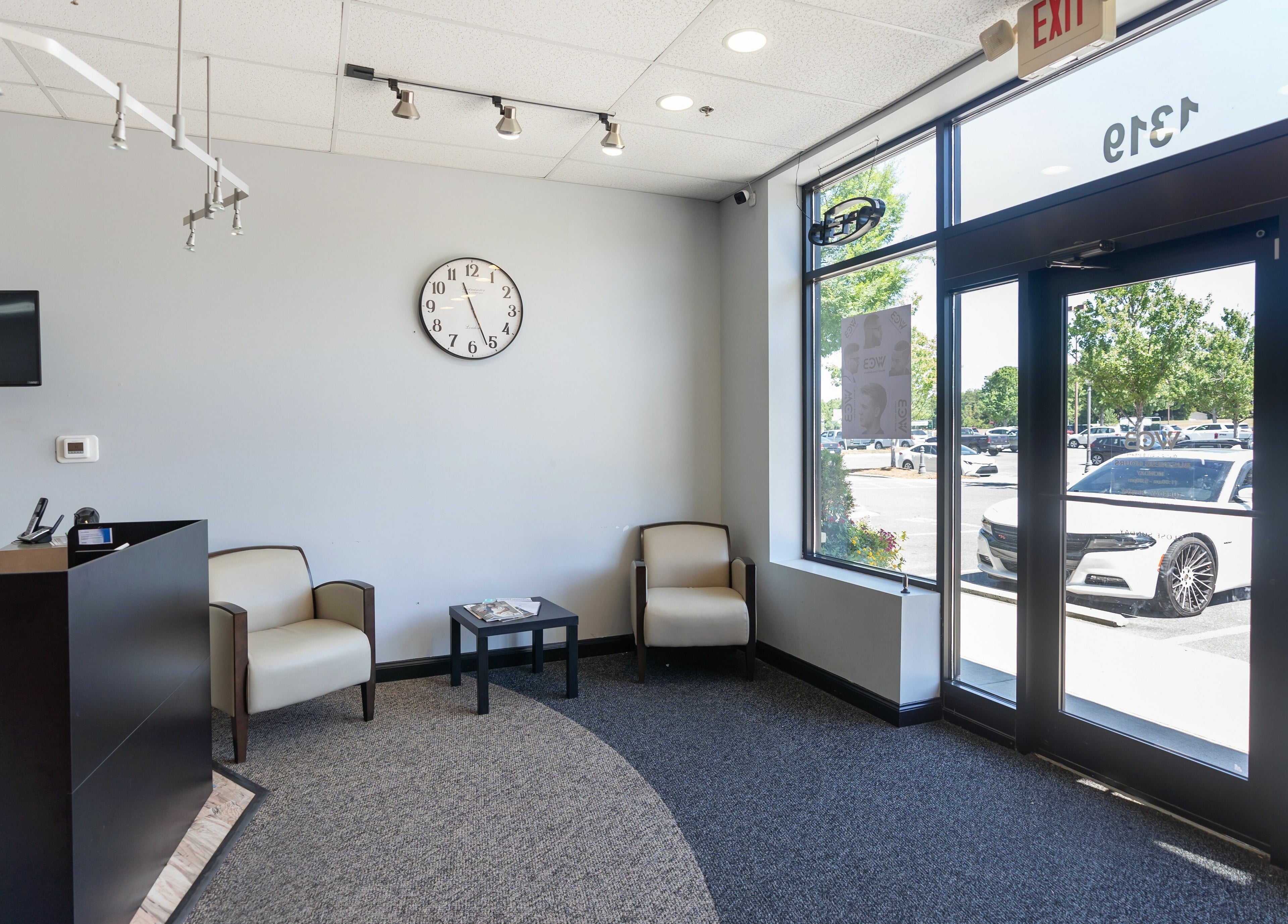 Reception area of World Class Barbers - Matthews with sleek seating and modern decor in Matthews, North Carolina, US.