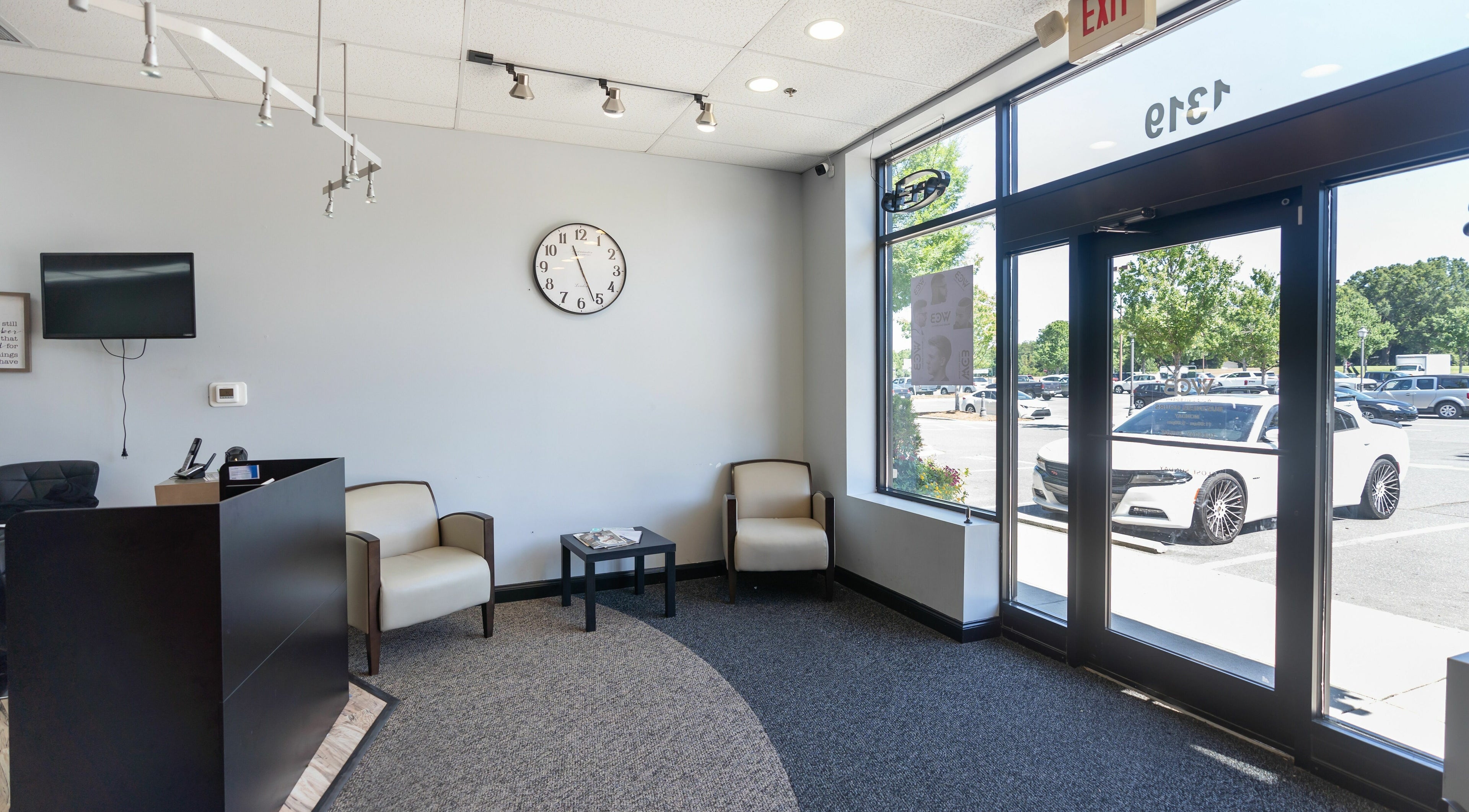 Reception area of World Class Barbers - Matthews with sleek seating and modern decor in Matthews, North Carolina, US.