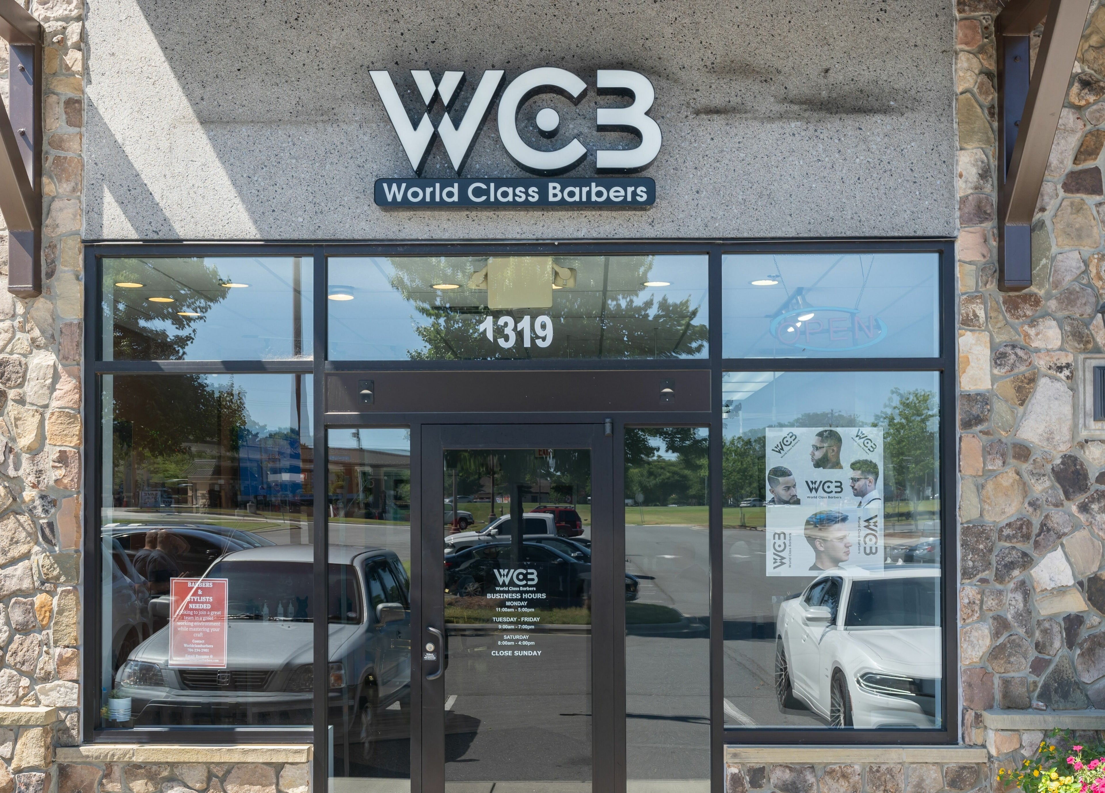Entrance of World Class Barbers - Matthews, showcasing modern glass facade in Matthews, North Carolina, US.