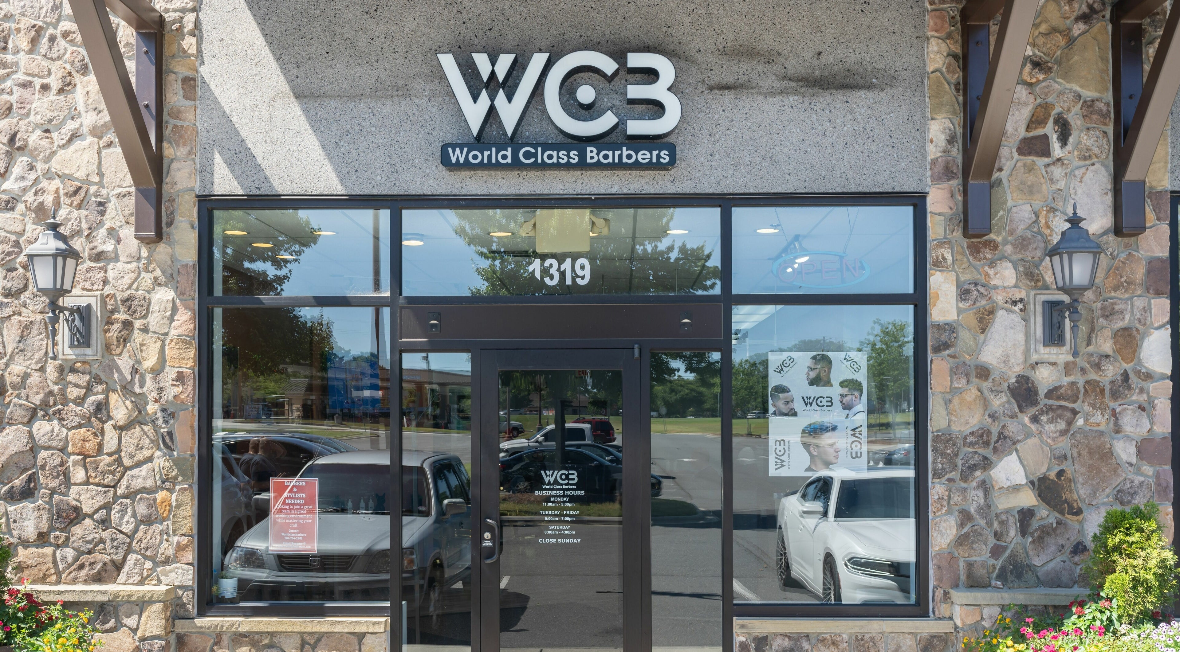 Entrance of World Class Barbers - Matthews, showcasing modern glass facade in Matthews, North Carolina, US.