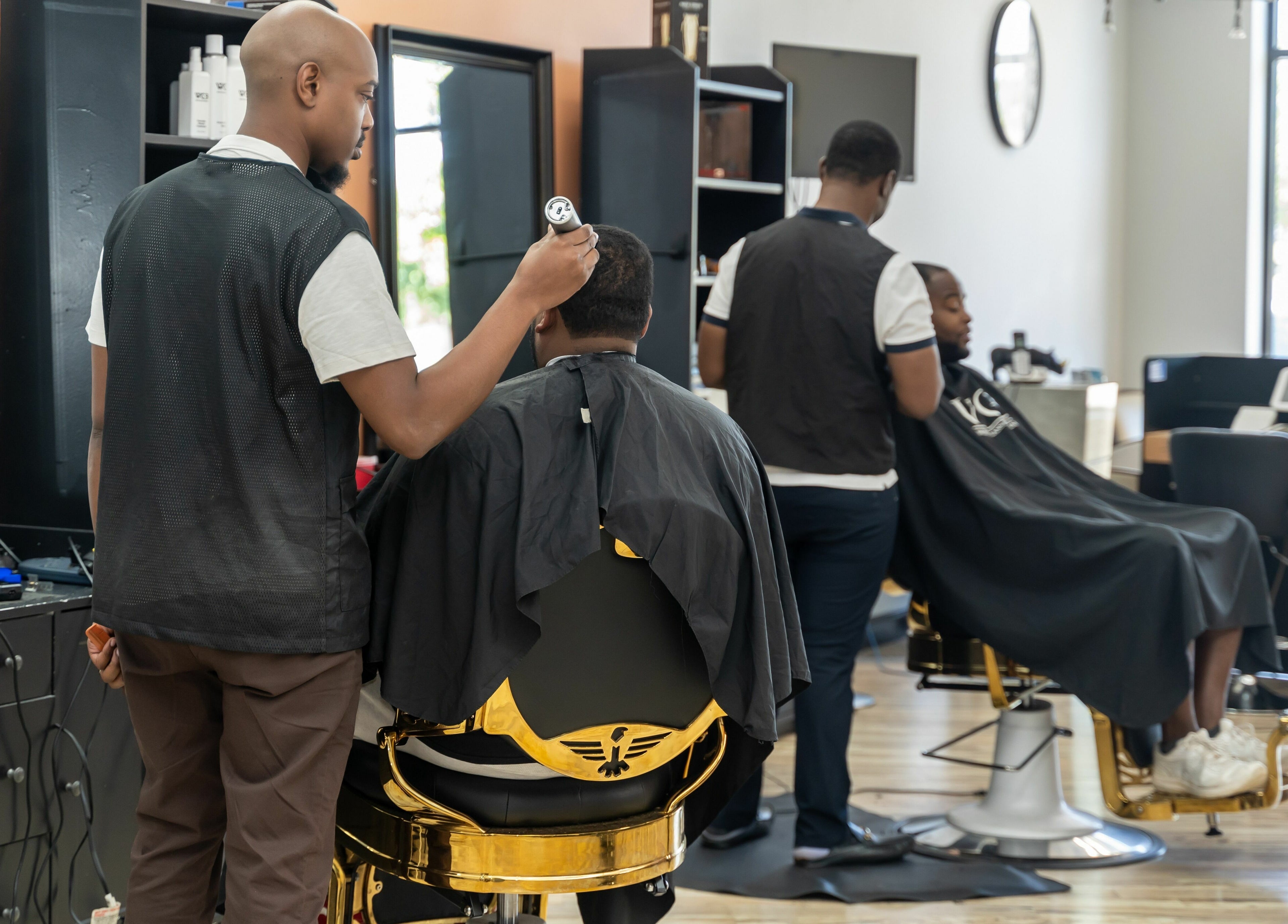 Skilled barber at World Class Barbers - Matthews, North Carolina, US crafting hairstyles for clients.