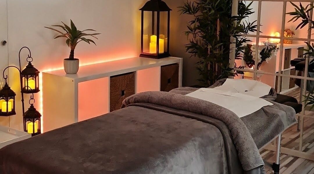 Relaxing massage room at The Beauty Collective Ni, Belfast, Northern Ireland, GB, with cozy lighting and decor.