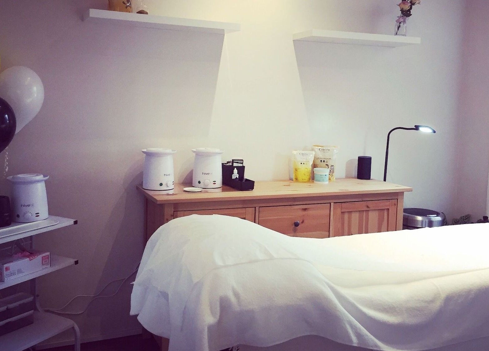 Elegant treatment room at The Wax Room, Paignton, England, GB with warm lighting and modern decor.