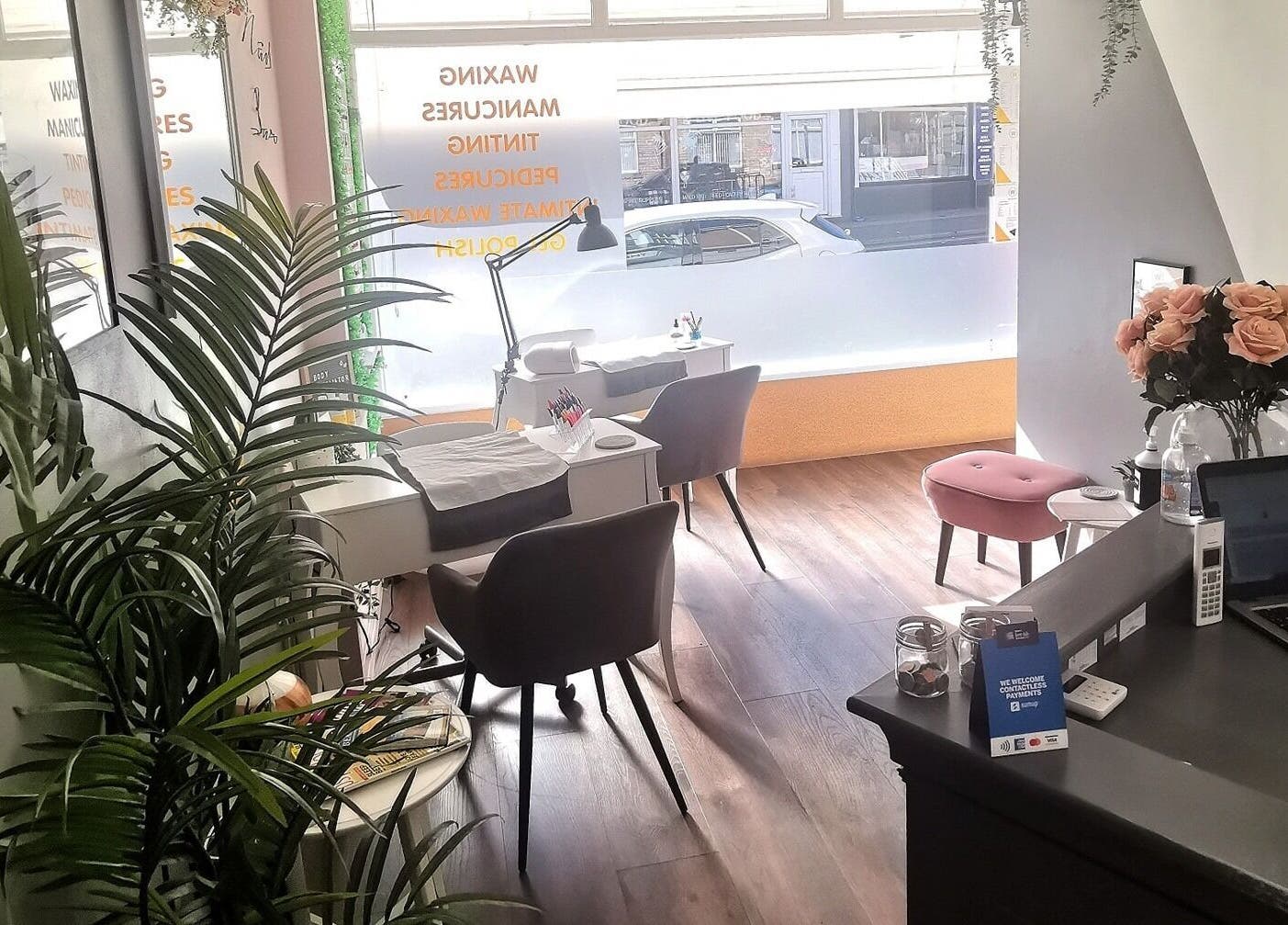 Cozy interior of The Wax Room, Paignton, England, GB, showcasing manicure stations with elegant decor.