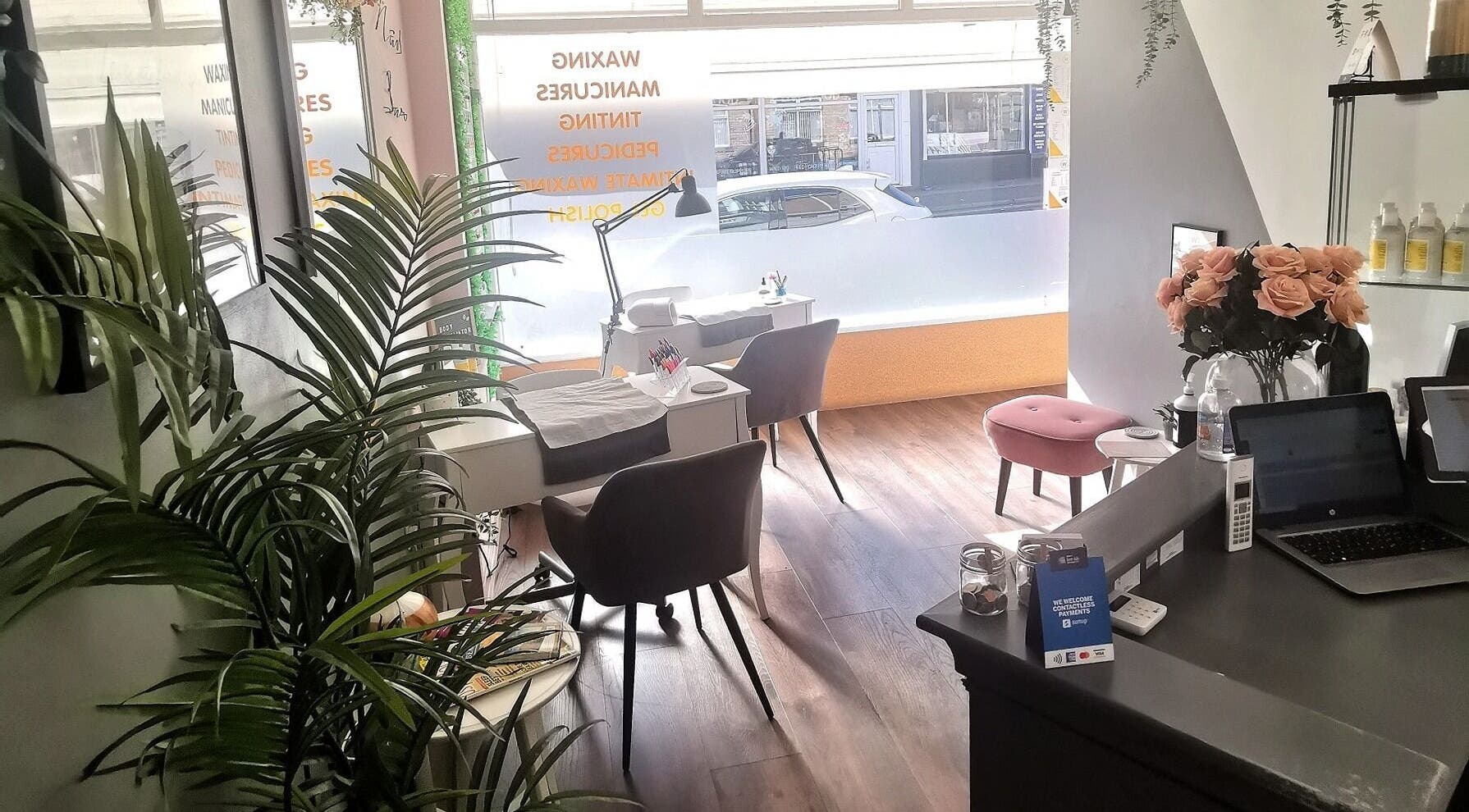 Cozy interior of The Wax Room, Paignton, England, GB, showcasing manicure stations with elegant decor.