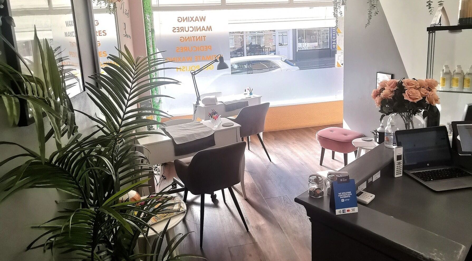 Cozy interior of The Wax Room, Paignton, England, GB, showcasing manicure stations with elegant decor.