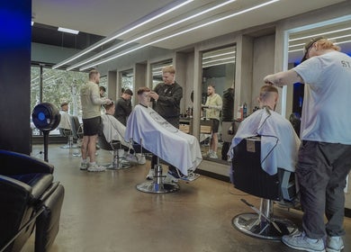 Modern barbershop at Old County Clondalkin, Dublin, County Dublin, IE. Stylists busy at work.