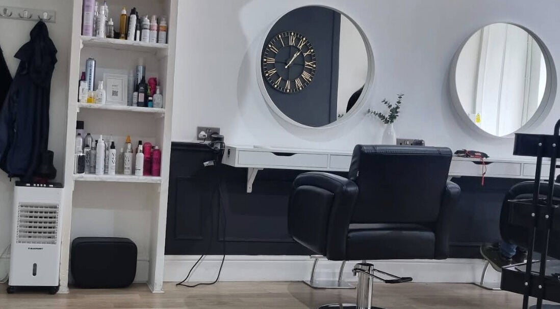 Modern salon interior at Becki Nettel Hair and Beauty, Burton upon Trent, England, GB with styling chairs and mirrors.